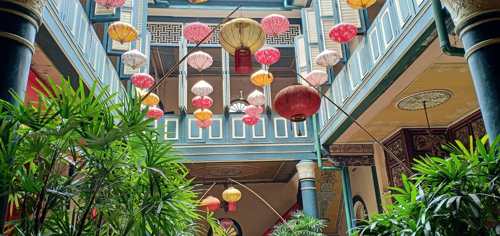 a building with many lanterns from the ceiling