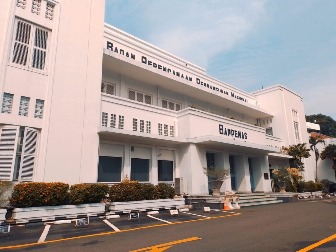 a large white building sitting on the side of a road